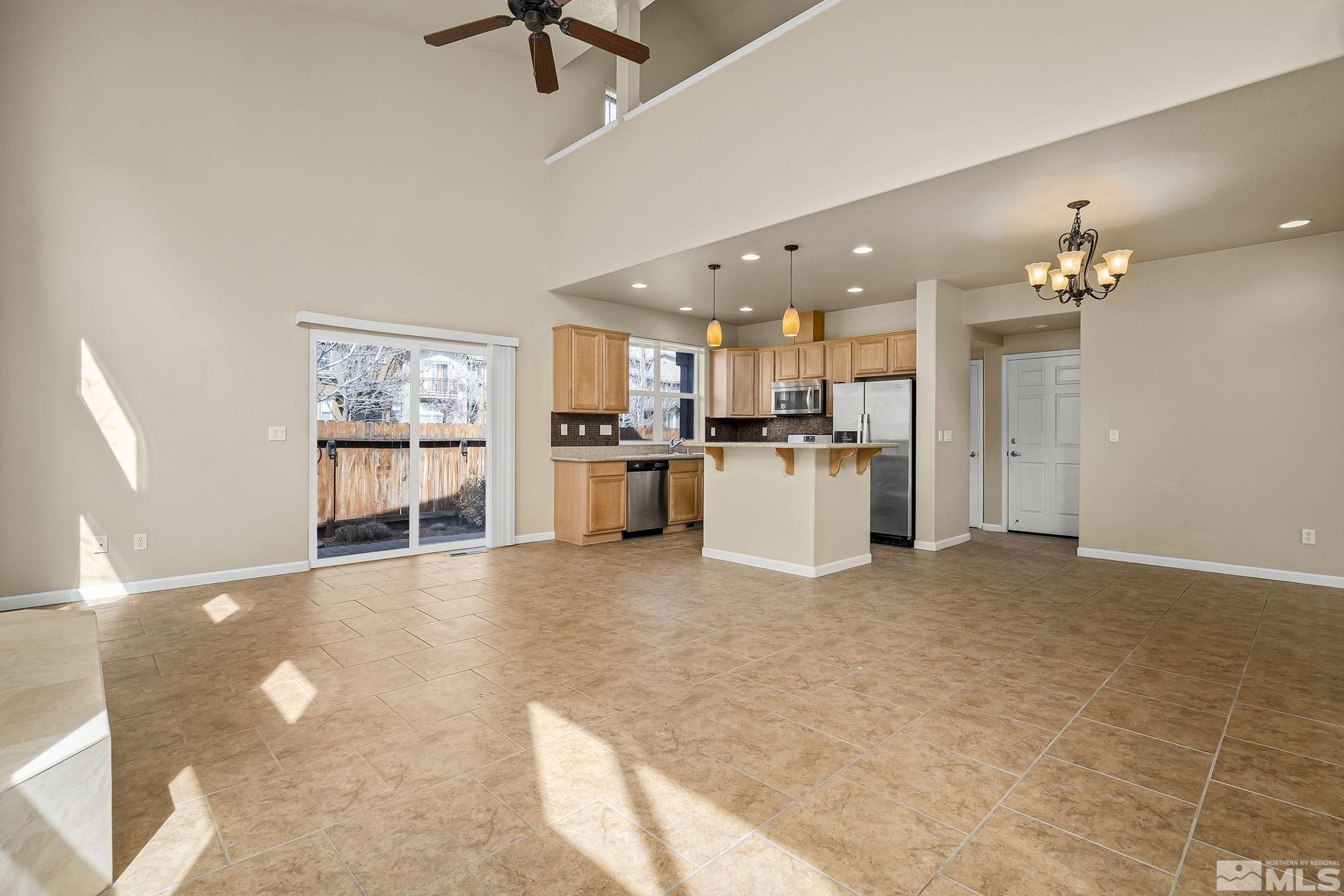 1026 Floral Ridge Way Sparks, NV 89436 - Photo 4 of 22 a view of a kitchen with a sink and a refrigerator