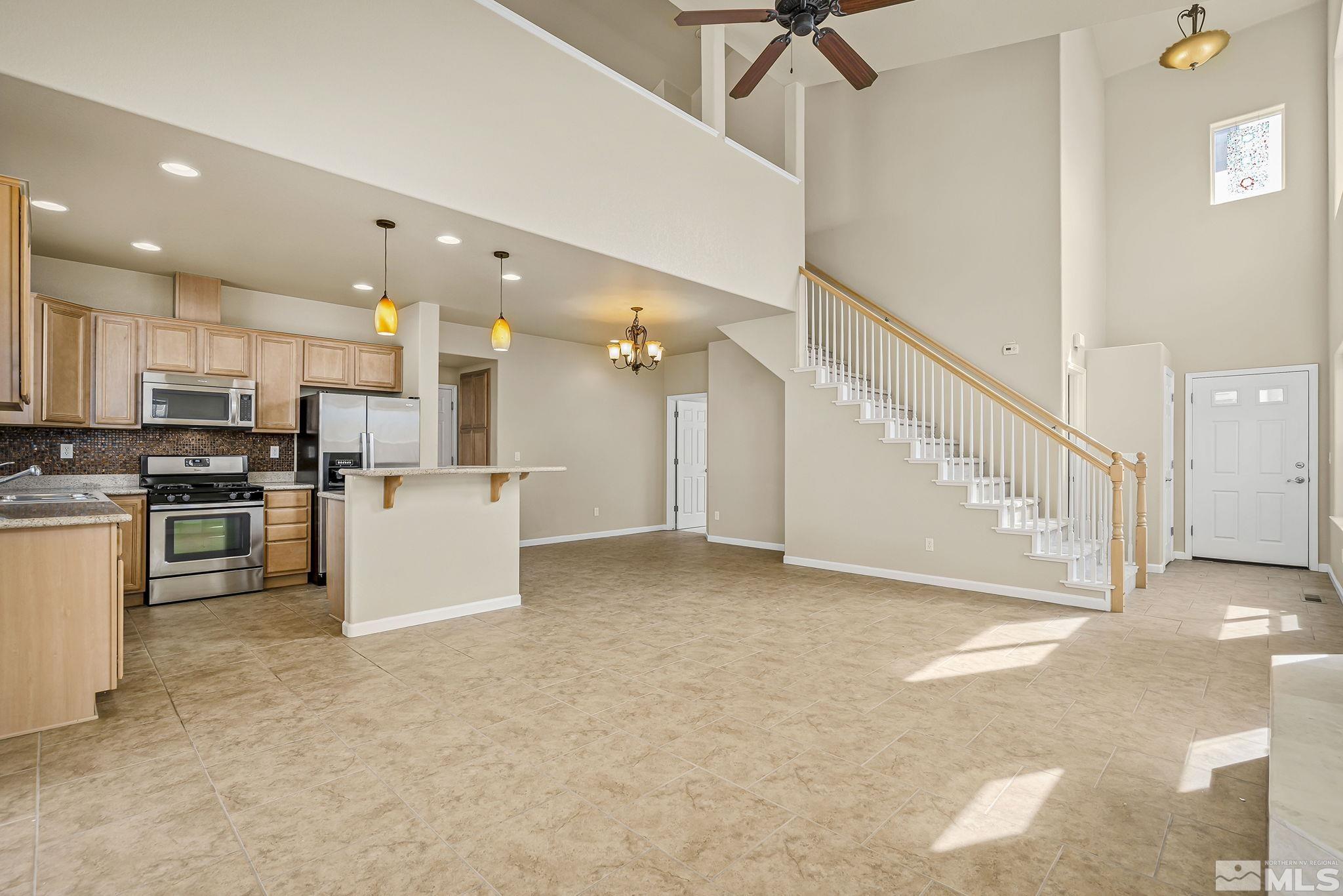 1026 Floral Ridge Way Sparks, NV 89436 - Photo 5 of 22 a view of open kitchen with cabinets and stainless steel appliances