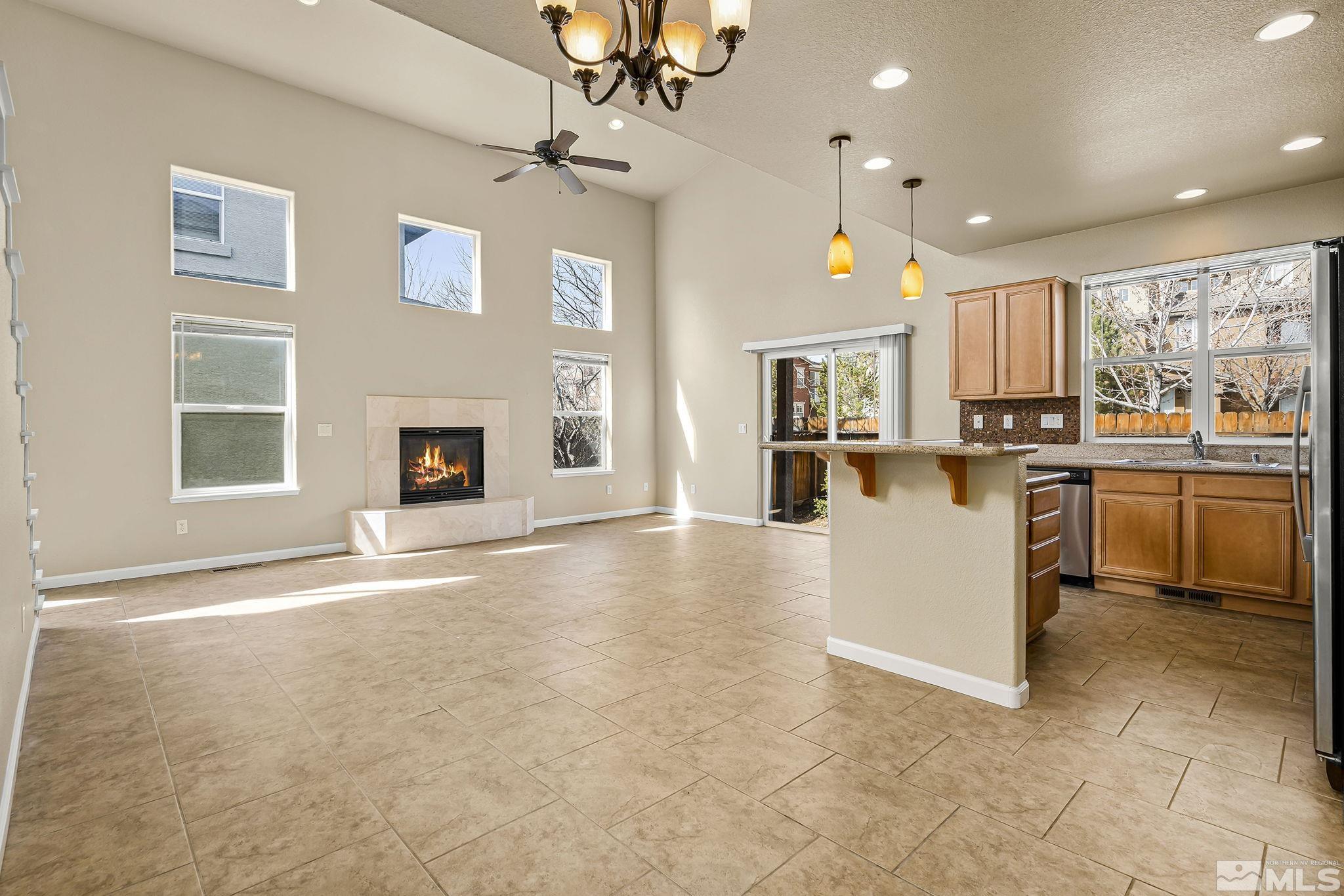 1026 Floral Ridge Way Sparks, NV 89436 - Photo 7 of 22 a view of a kitchen with a sink a microwave and cabinets