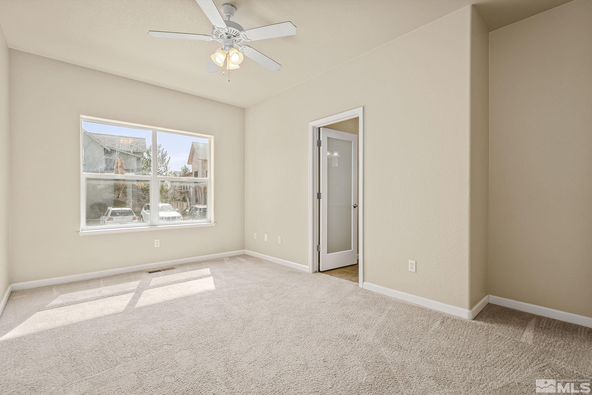 1026 Floral Ridge Way Sparks, NV 89436 - Photo 10 of 22 an empty room with windows and fan