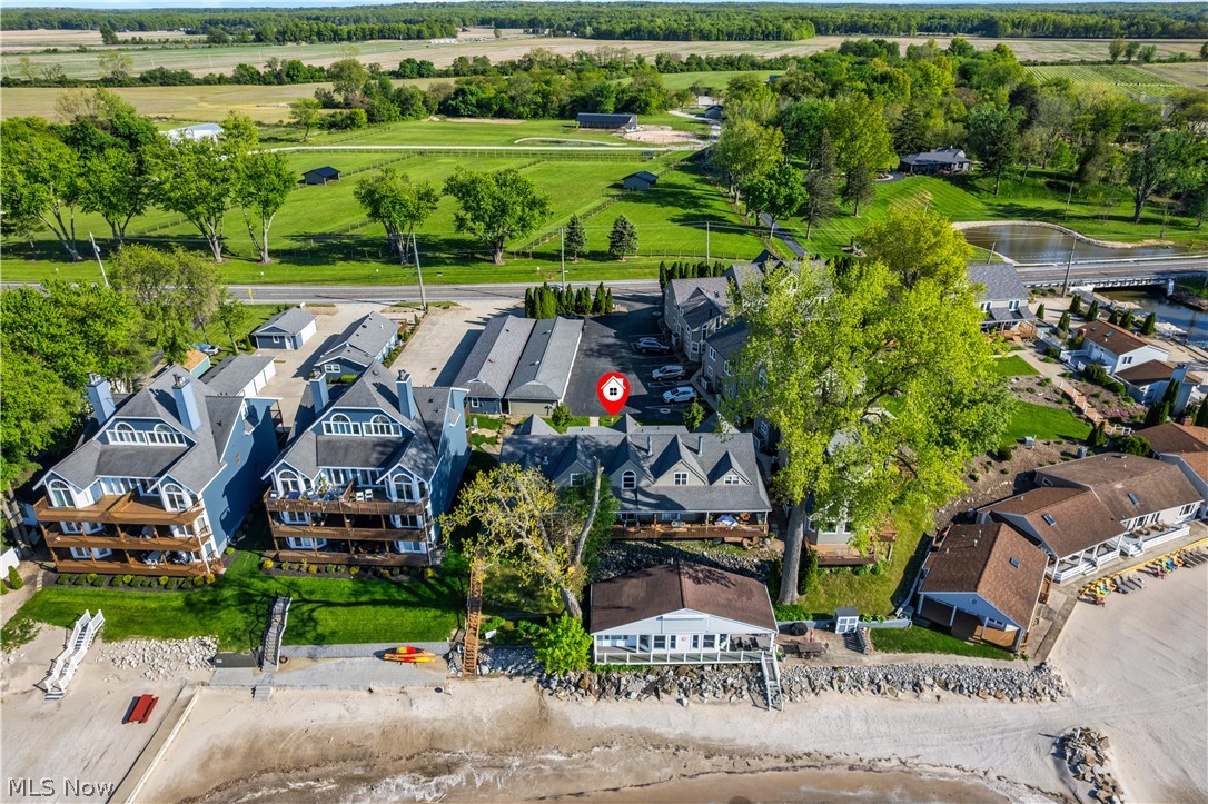 13011 West Lake Road Vermilion, OH 44089 - Photo 2 of 29 Waterfront property featuring multiple structures, private beach access, and surrounding green spaces