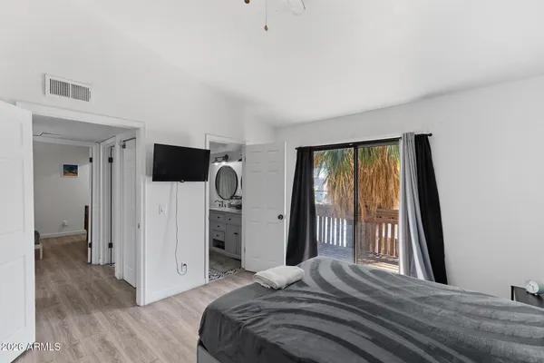 a bedroom with a bed and a chandelier