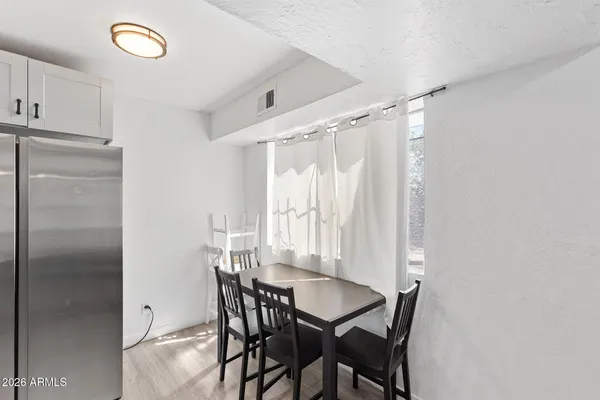 a view of a dining room with furniture and a window