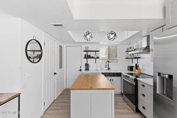 a kitchen with a sink a stove and cabinets