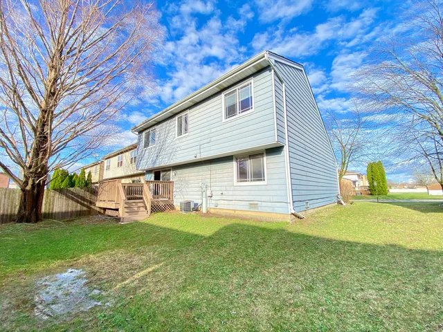 a view of a brick house with a large window