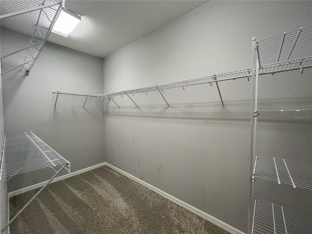 26391 Limestone Springs Way Wesley Chapel, FL 33544 - Photo 12 of 16 a view of a room with racks on the wall