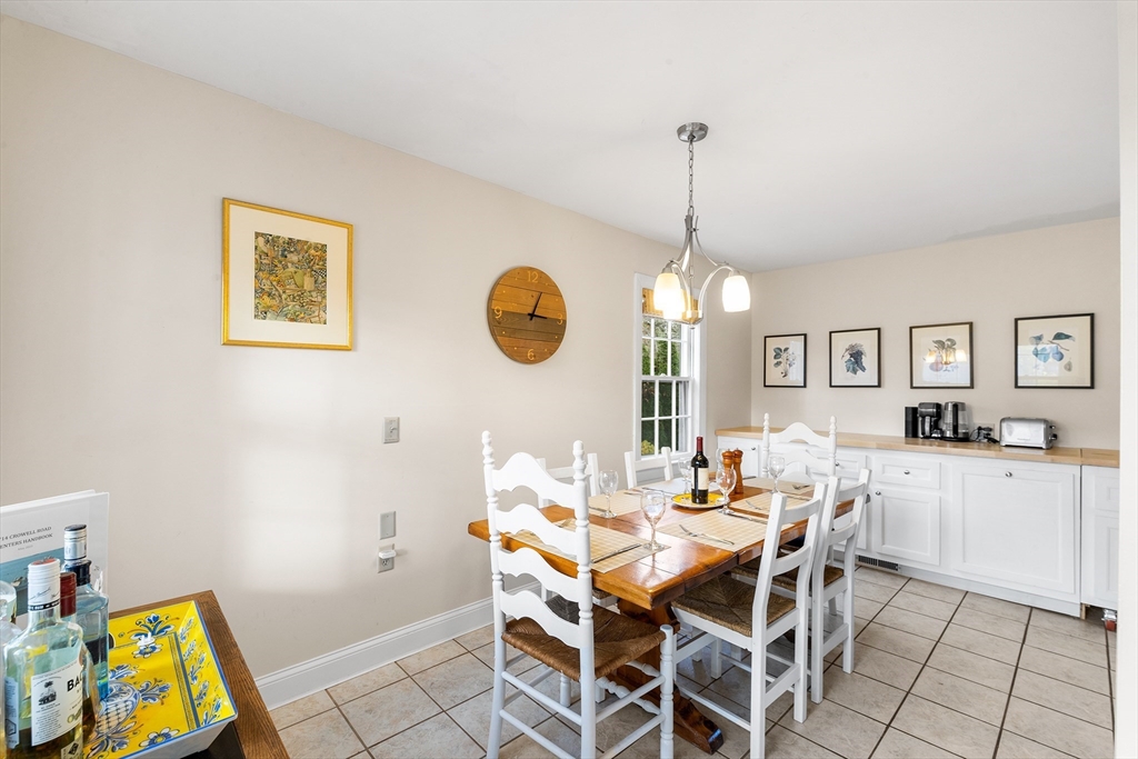 714 Crowell Road Chatham, MA 02650 - Photo 5 of 41 a dining room with chandelier fan and wooden floor