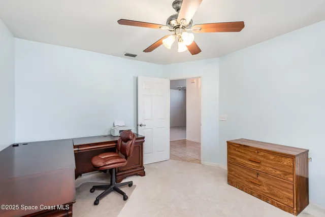 a room with furniture and a ceiling fan