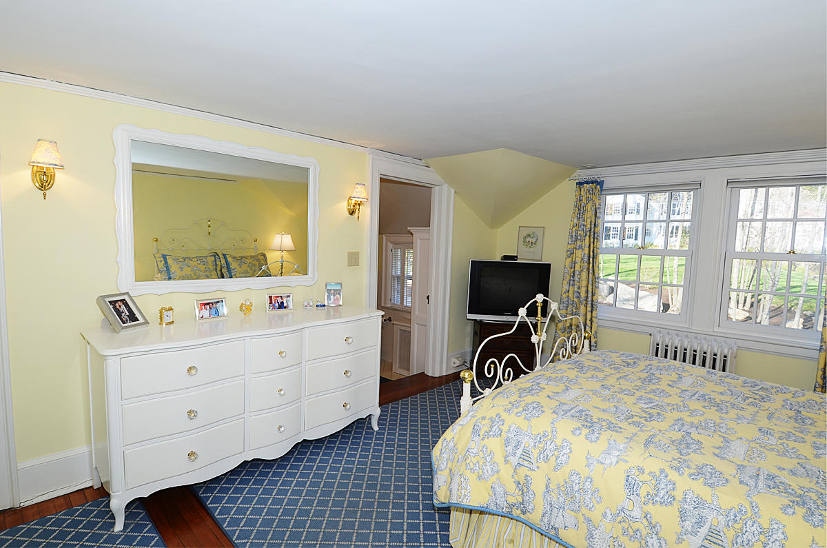 112 Brushy Ridge Road New Canaan, CT 06840 - Photo 24 of 45 a room with a bed and a flat tv screen on dresser
