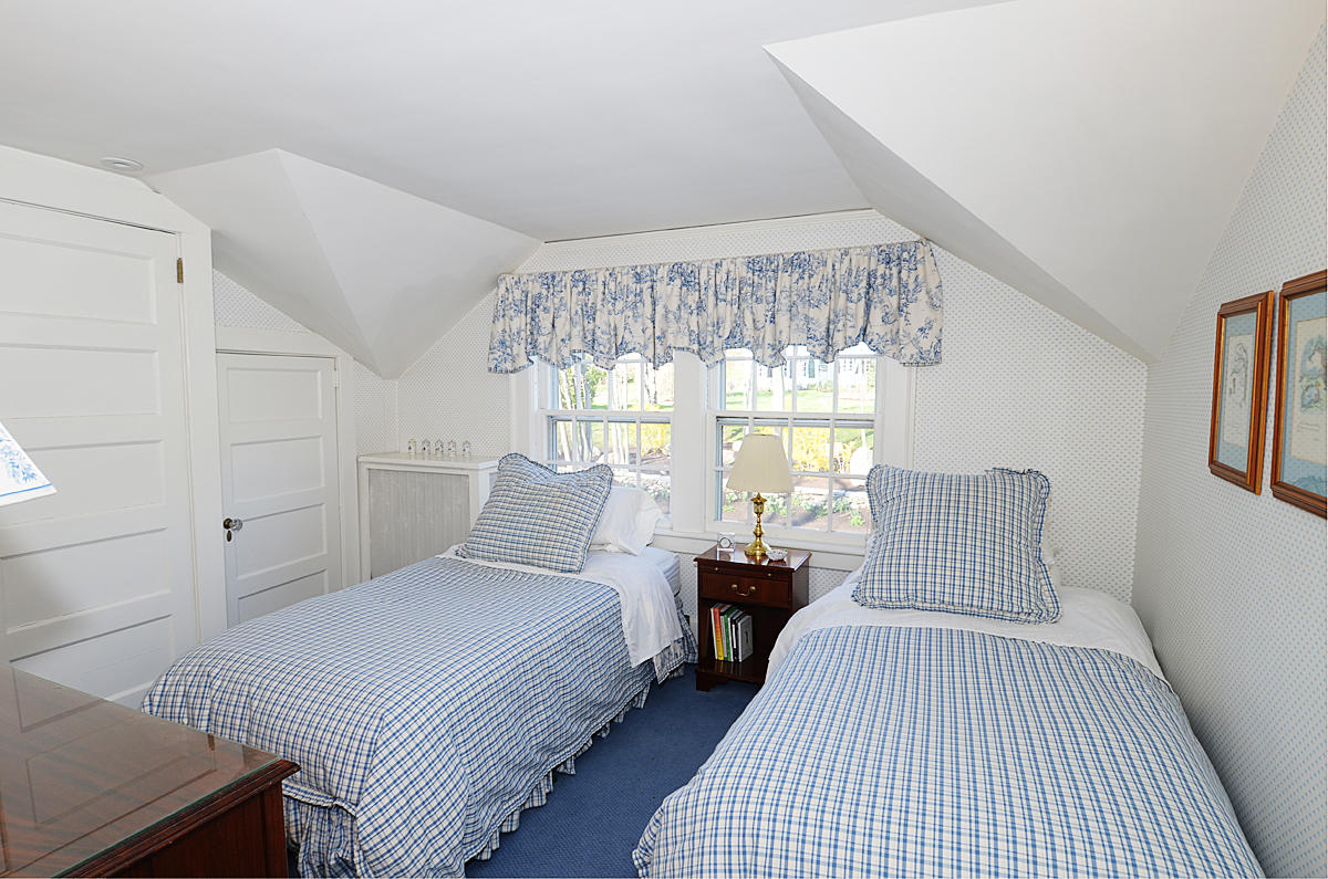 112 Brushy Ridge Road New Canaan, CT 06840 - Photo 26 of 45 a bedroom with a large bed and a chandelier