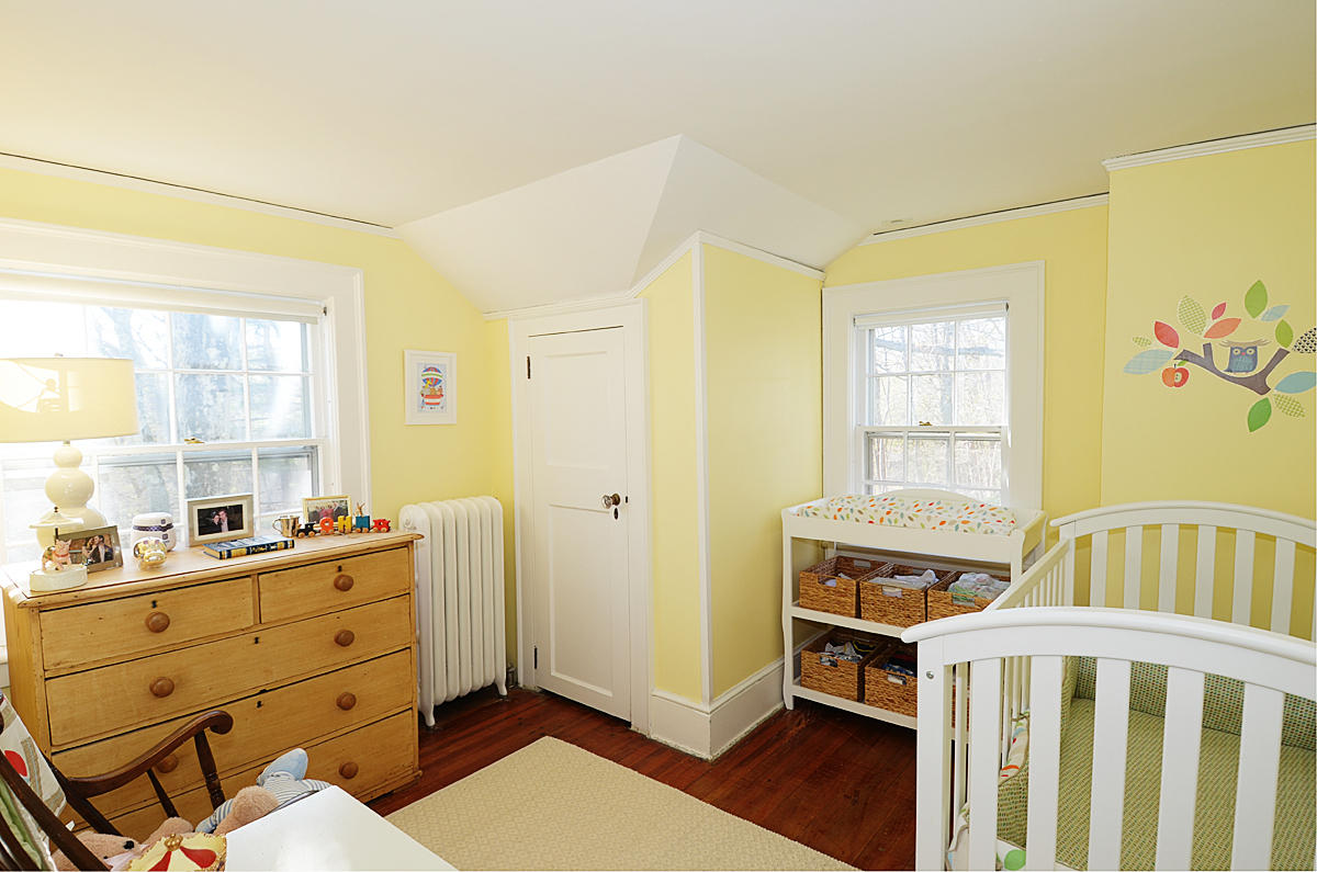 112 Brushy Ridge Road New Canaan, CT 06840 - Photo 27 of 45 a bedroom with a baby bed a window and a dresser