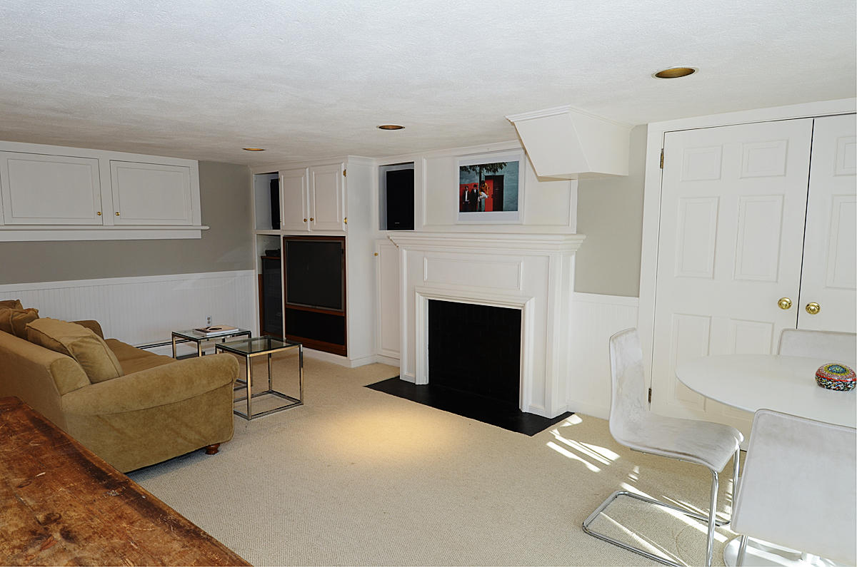 112 Brushy Ridge Road New Canaan, CT 06840 - Photo 30 of 45 a living room with furniture and a fireplace
