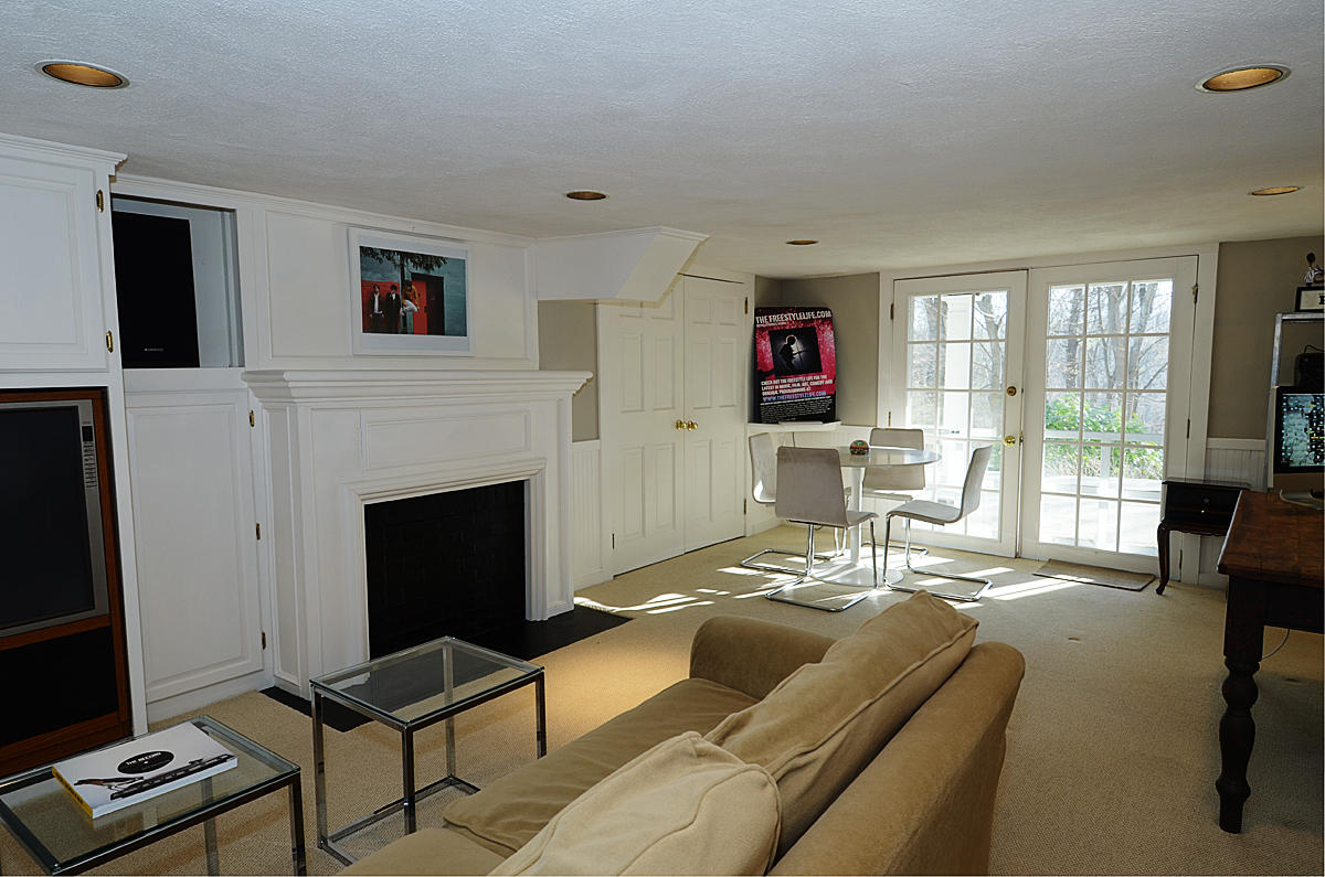 112 Brushy Ridge Road New Canaan, CT 06840 - Photo 31 of 45 a living room with furniture and a fireplace
