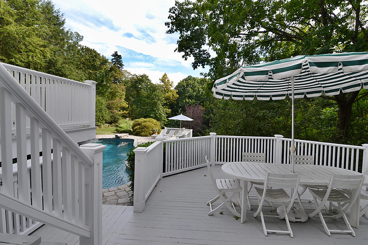 112 Brushy Ridge Road New Canaan, CT 06840 - Photo 44 of 45 a view of a patio with a table chairs and a fireplace