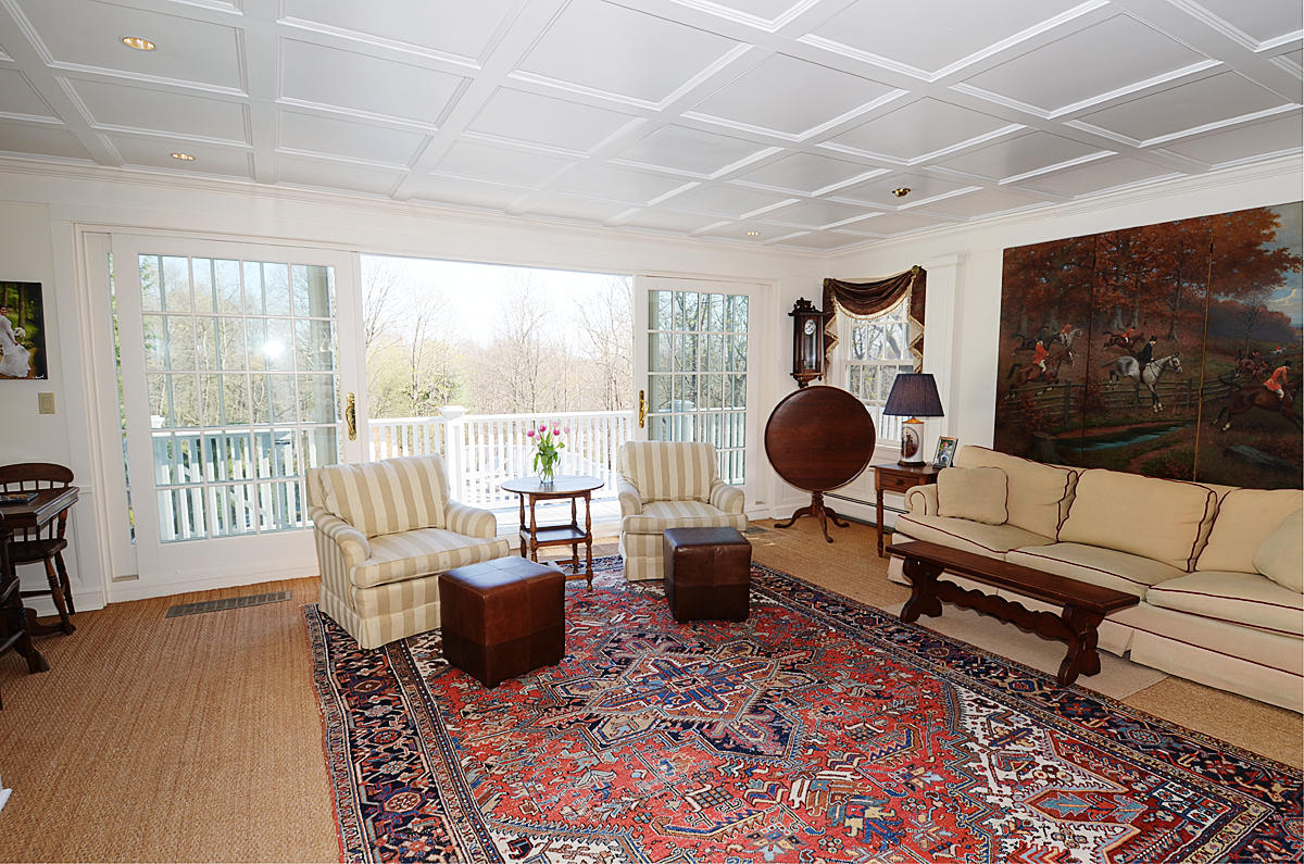 112 Brushy Ridge Road New Canaan, CT 06840 - Photo 10 of 45 a living room with furniture and a floor to ceiling window