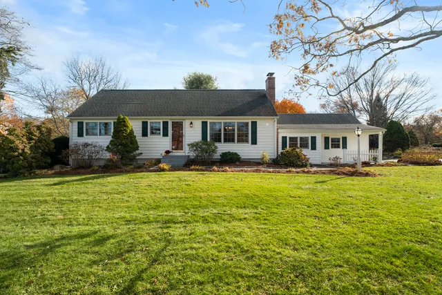 a front view of house with yard and outdoor seating