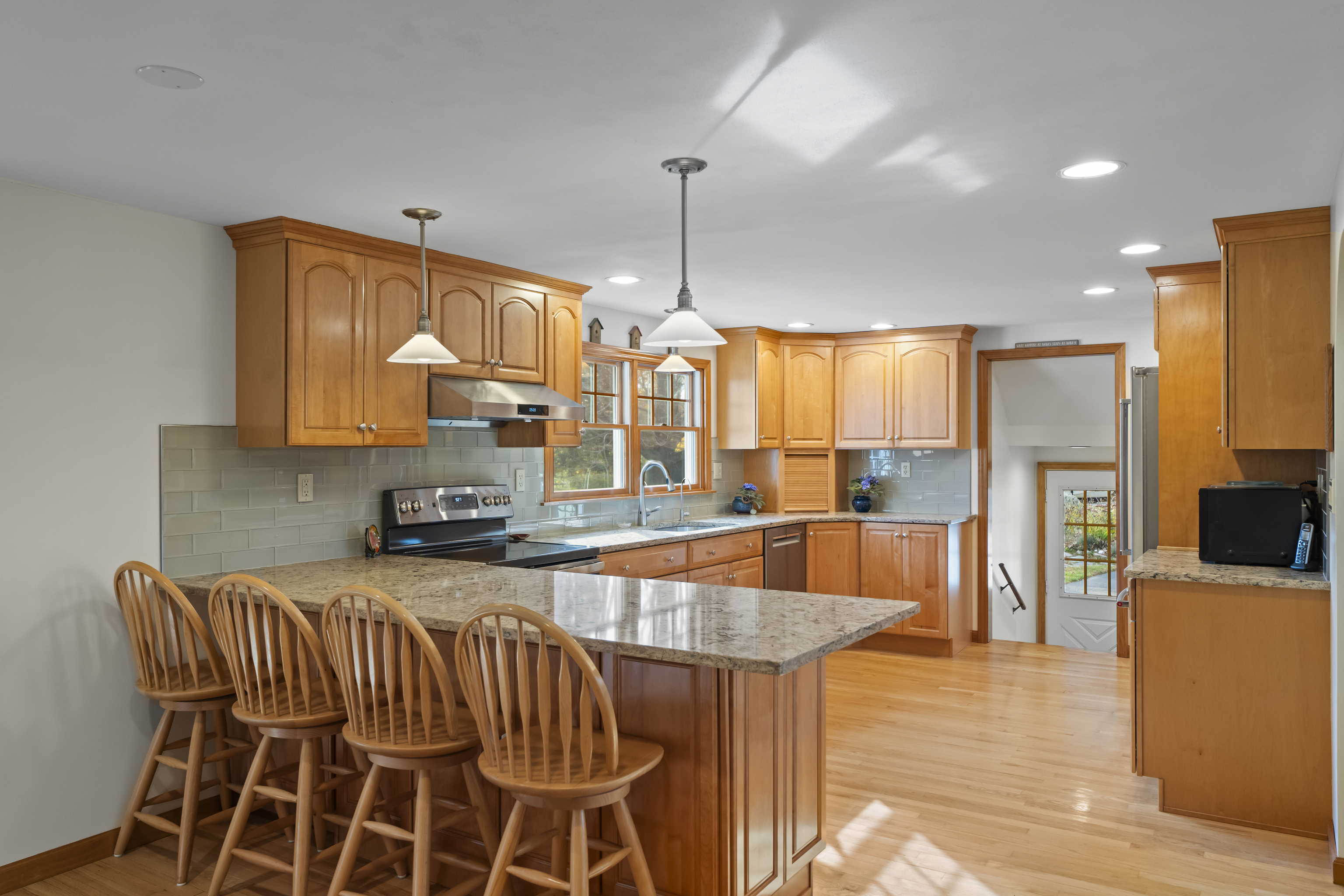 452 Colonel Ledyard Highway Ledyard, CT 06339 - Photo 10 of 35 a kitchen with stainless steel appliances kitchen island granite countertop a table chairs and a refrigerator