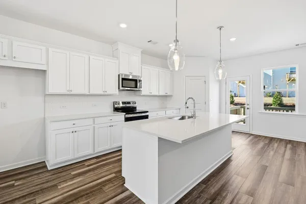 a kitchen with kitchen island white cabinets and white appliances