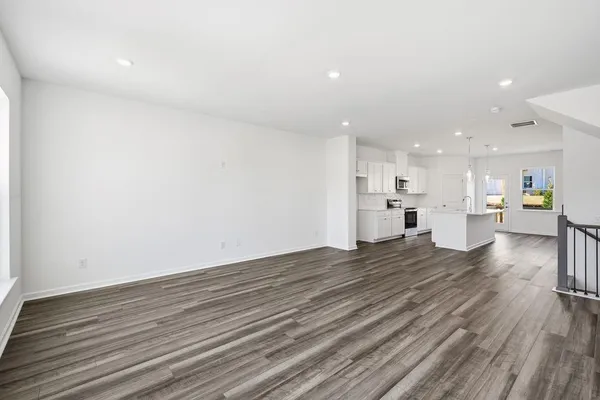 a view of kitchen and kitchen island wooden floor