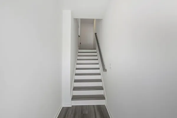 a view of a hallway with wooden floor and entryway