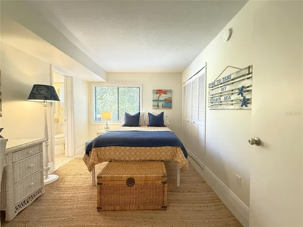 a bed sitting in a bedroom next to a window