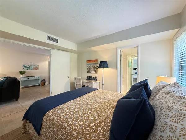 a bedroom with a bed and a couch