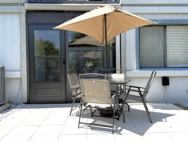 a patio with a table and chairs