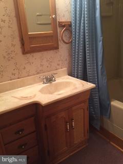 1522 Burnfield Road Baltimore, MD 21237 - Photo 19 of 20 a bathroom with a sink and a mirror
