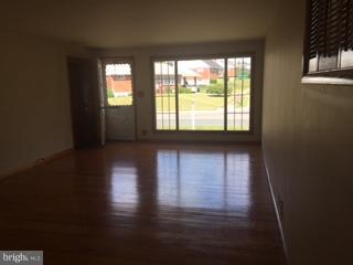 1522 Burnfield Road Baltimore, MD 21237 - Photo 3 of 20 a view of empty room with wooden floor and fan