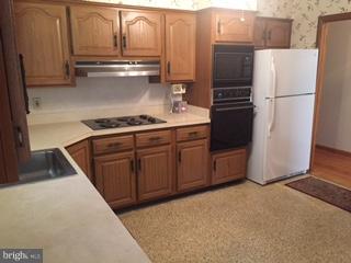 1522 Burnfield Road Baltimore, MD 21237 - Photo 4 of 20 a kitchen with a refrigerator and a stove