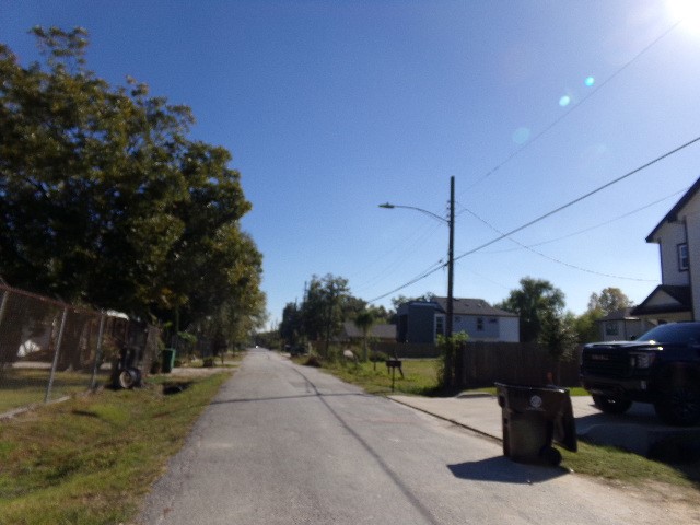 0 Queen Street Houston, TX 77028 - Photo 4 of 4 a view of a road with a bench in front of it