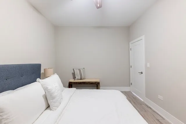 a bedroom with a bed and chair