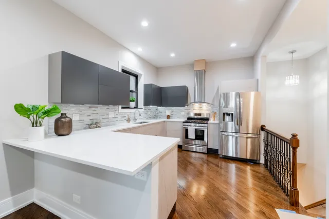 a kitchen with granite countertop a sink stainless steel appliances and cabinets