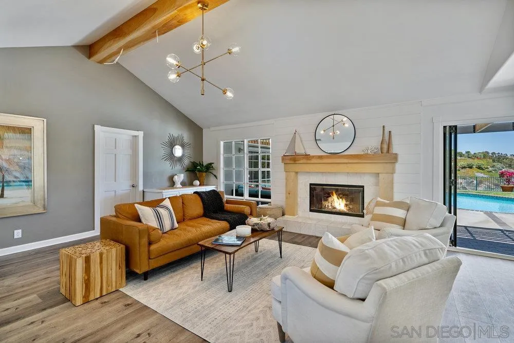 5771 Rutgers Road La Jolla, CA 92037 - Photo 12 of 75 a living room with furniture a clock and a fireplace