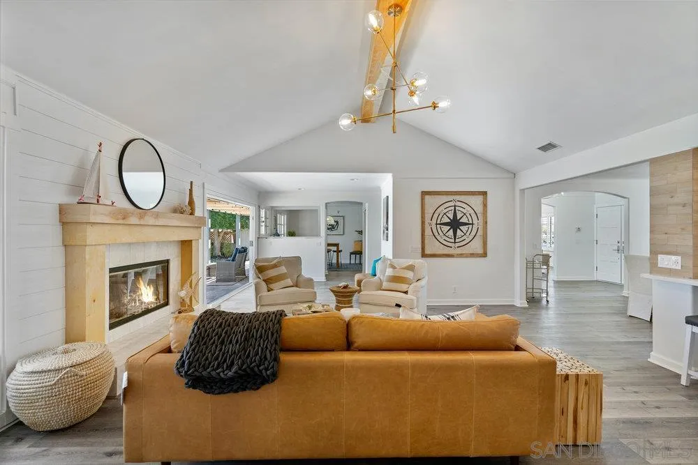 5771 Rutgers Road La Jolla, CA 92037 - Photo 15 of 75 a living room with furniture a fireplace and a chandelier