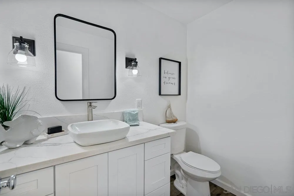 5771 Rutgers Road La Jolla, CA 92037 - Photo 18 of 75 a bathroom with a toilet sink and mirror