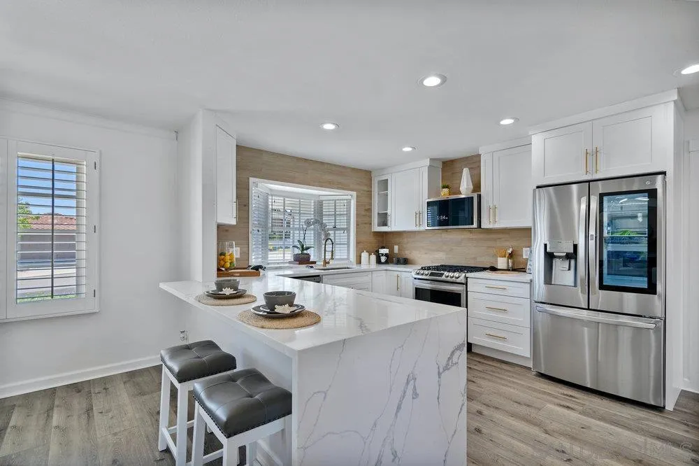 5771 Rutgers Road La Jolla, CA 92037 - Photo 24 of 75 a kitchen with refrigerator cabinets and wooden floor