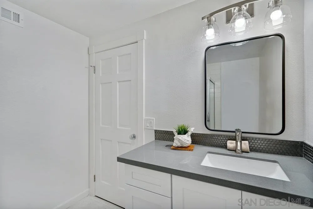 5771 Rutgers Road La Jolla, CA 92037 - Photo 41 of 75 a bathroom with a sink and a mirror
