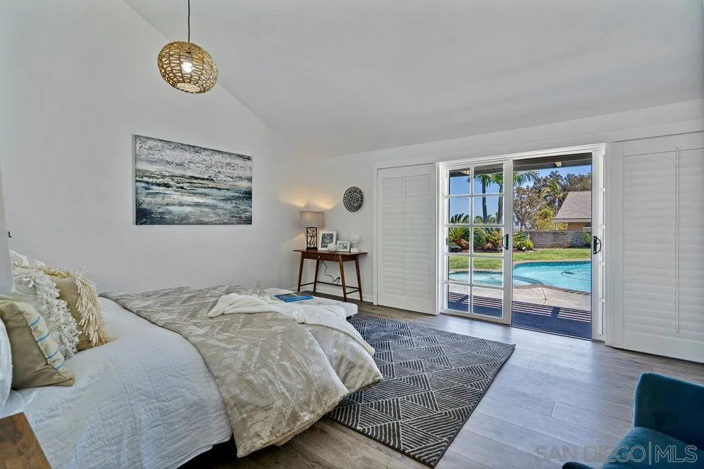 5771 Rutgers Road La Jolla, CA 92037 - Photo 46 of 75 a bedroom with a bed and a clock on the dresser