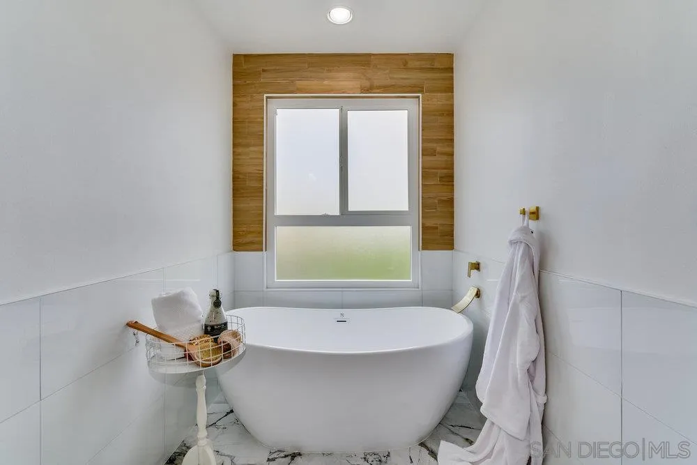 5771 Rutgers Road La Jolla, CA 92037 - Photo 49 of 75 a bath tub sitting in a bathroom next to a window