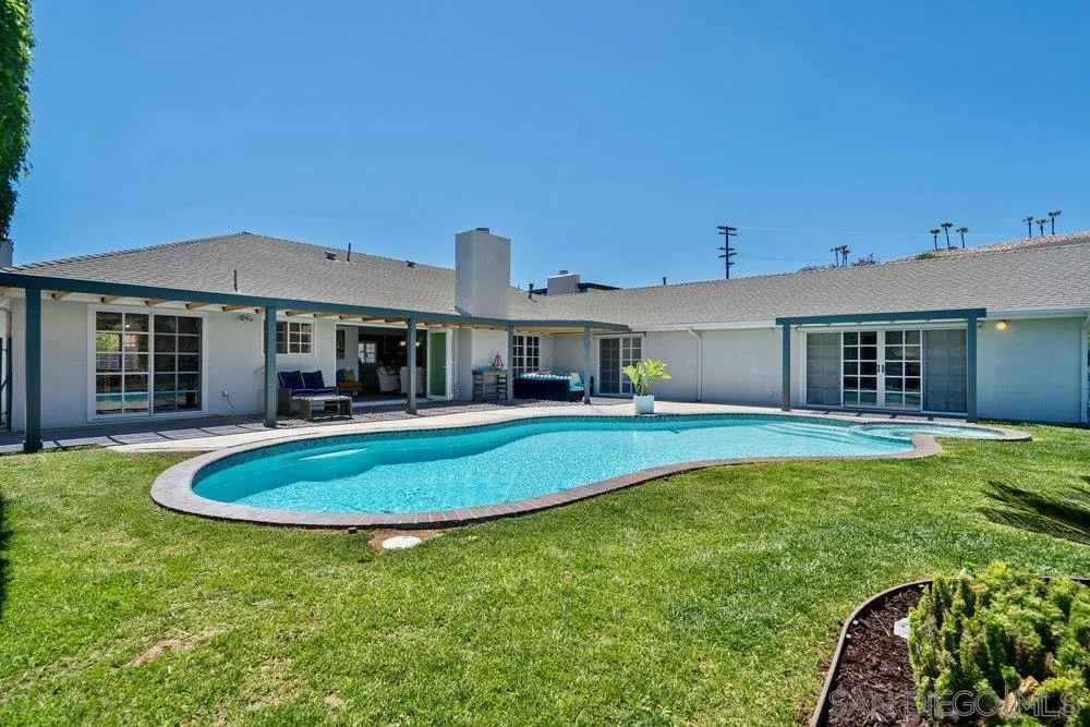 5771 Rutgers Road La Jolla, CA 92037 - Photo 60 of 75 a front view of a house with a yard fire pit and outdoor seating