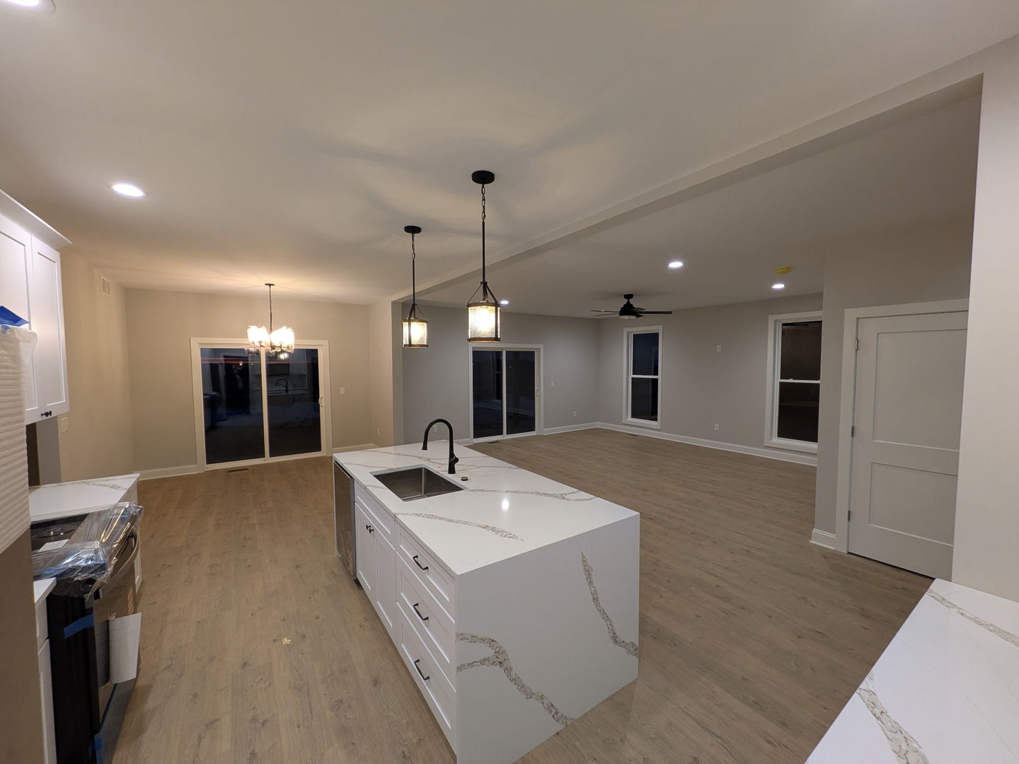 675 South Regulators Street Rochelle, IL 61068 - Photo 9 of 26 a kitchen with kitchen island a sink and a stove with wooden floor