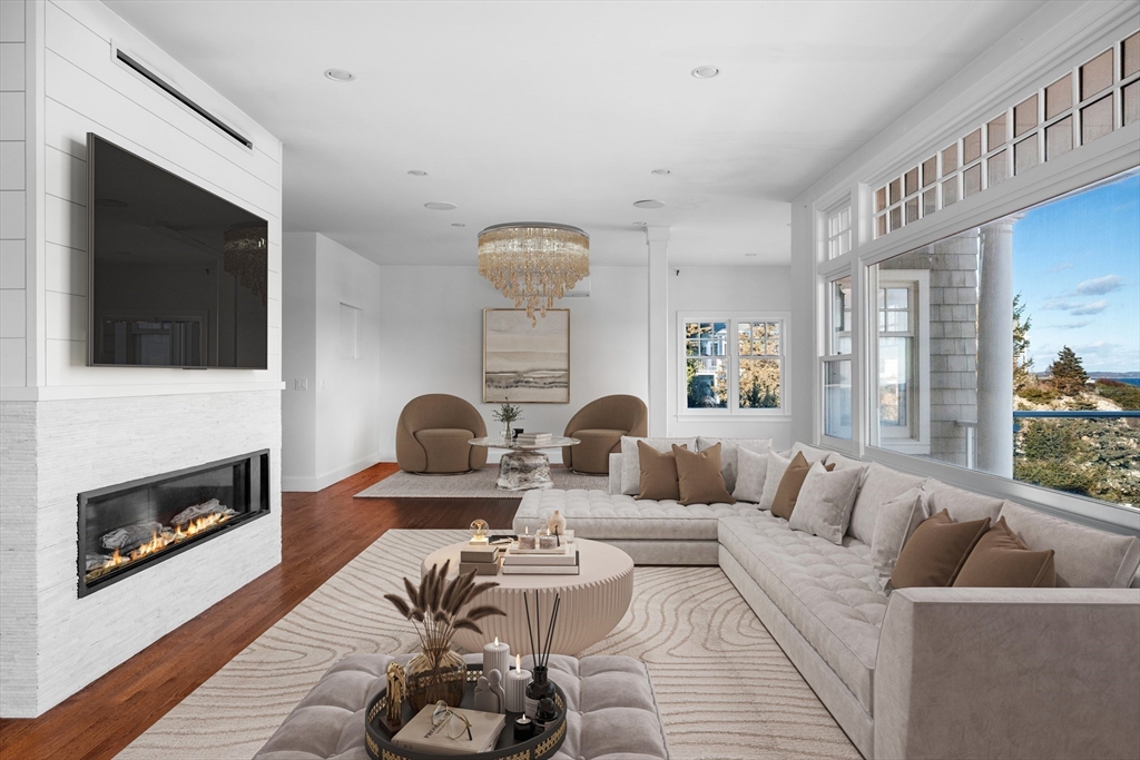 349 Ocean Avenue Marblehead, MA 01945 - Photo 2 of 23 a living room with furniture a flat screen tv and a fireplace