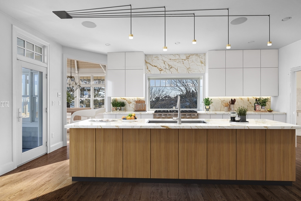 349 Ocean Avenue Marblehead, MA 01945 - Photo 3 of 23 a kitchen with kitchen island granite countertop a sink cabinets and window