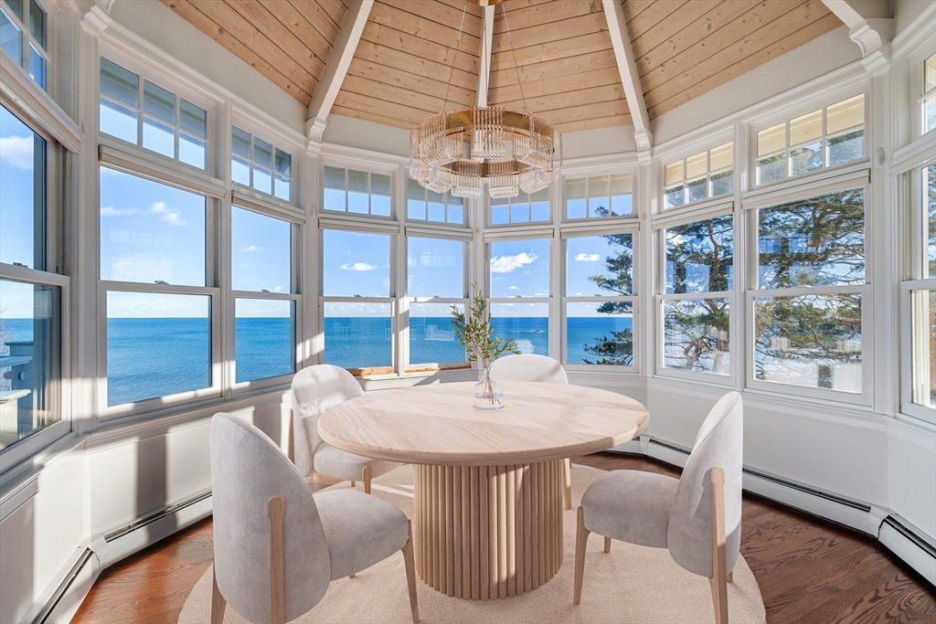 349 Ocean Avenue Marblehead, MA 01945 - Photo 4 of 23 a view of a dining room with furniture large windows and wooden floor