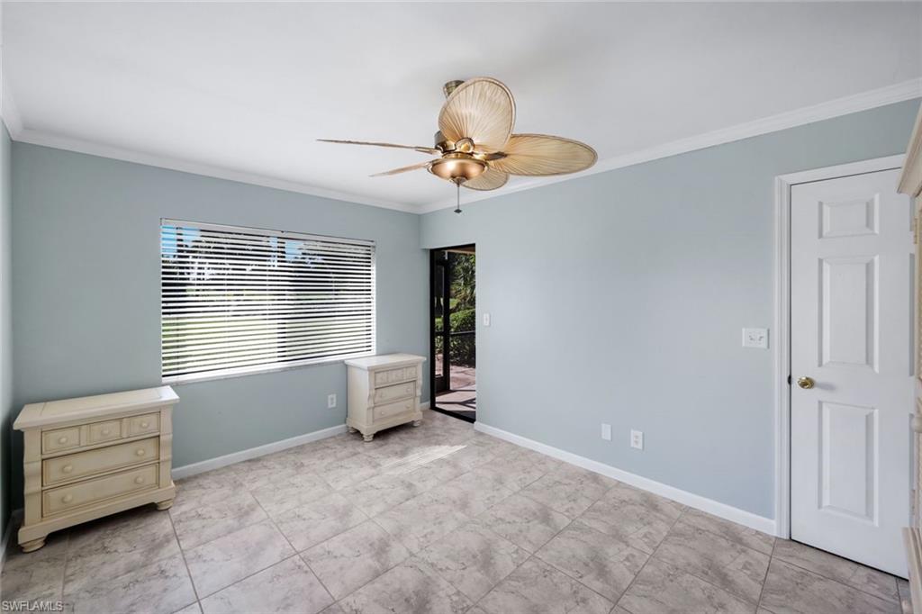 5857 Rattlesnake Hammock Road, Unit 101 Naples, FL 34113 - Photo 13 of 19 Light blue walls with white crown molding and baseboards