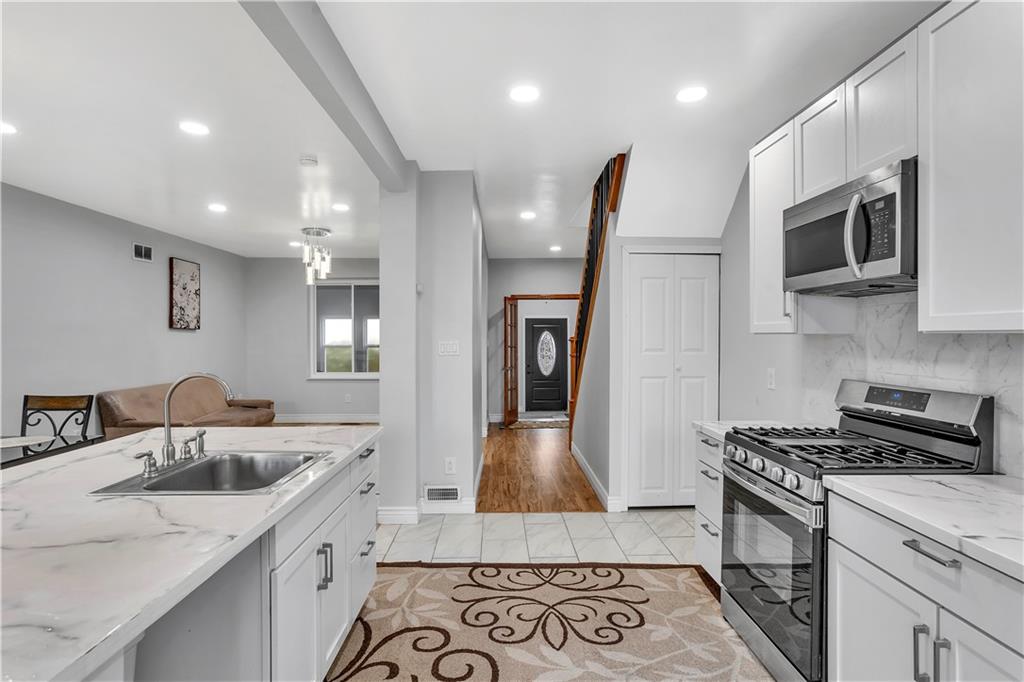 25 Clearview Avenue Duquesne, PA 15110 - Photo 12 of 33 a kitchen with stainless steel appliances granite countertop a sink stove and microwave