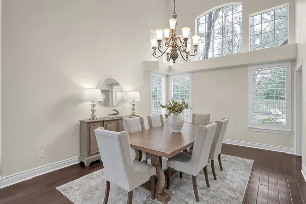 a kitchen with kitchen island granite countertop a sink cabinets and wooden floor