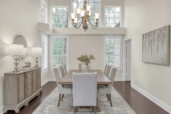 a large kitchen with a table and chairs