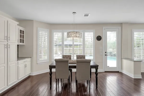 an empty room with a ceiling fan and window